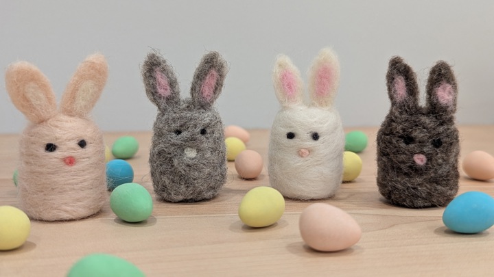 Assorted felted bunny decorations with button noses and cute tails.