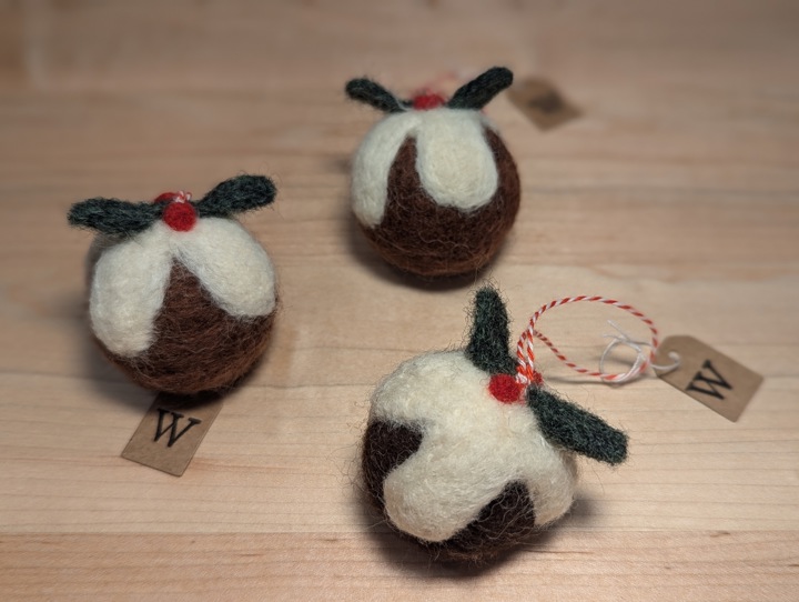 Felted decorations for a Christmas tree in the shape of Christmas puddings.